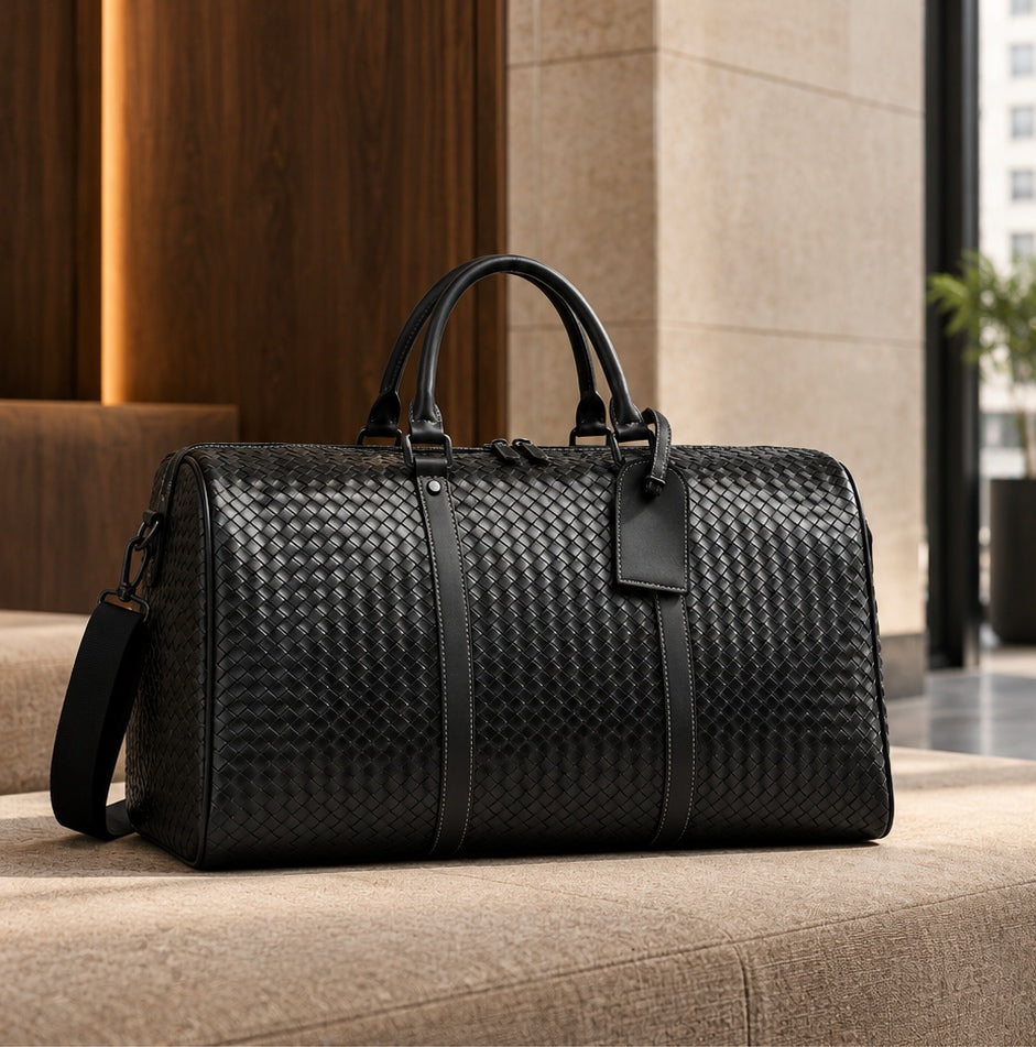 Black woven duffel on a stone-coloured upholstered bench